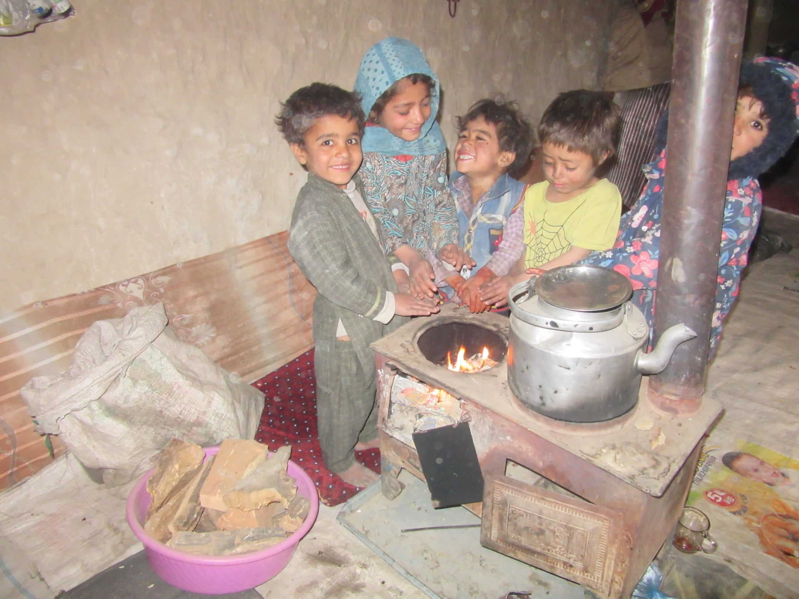 Refugee children around small fire