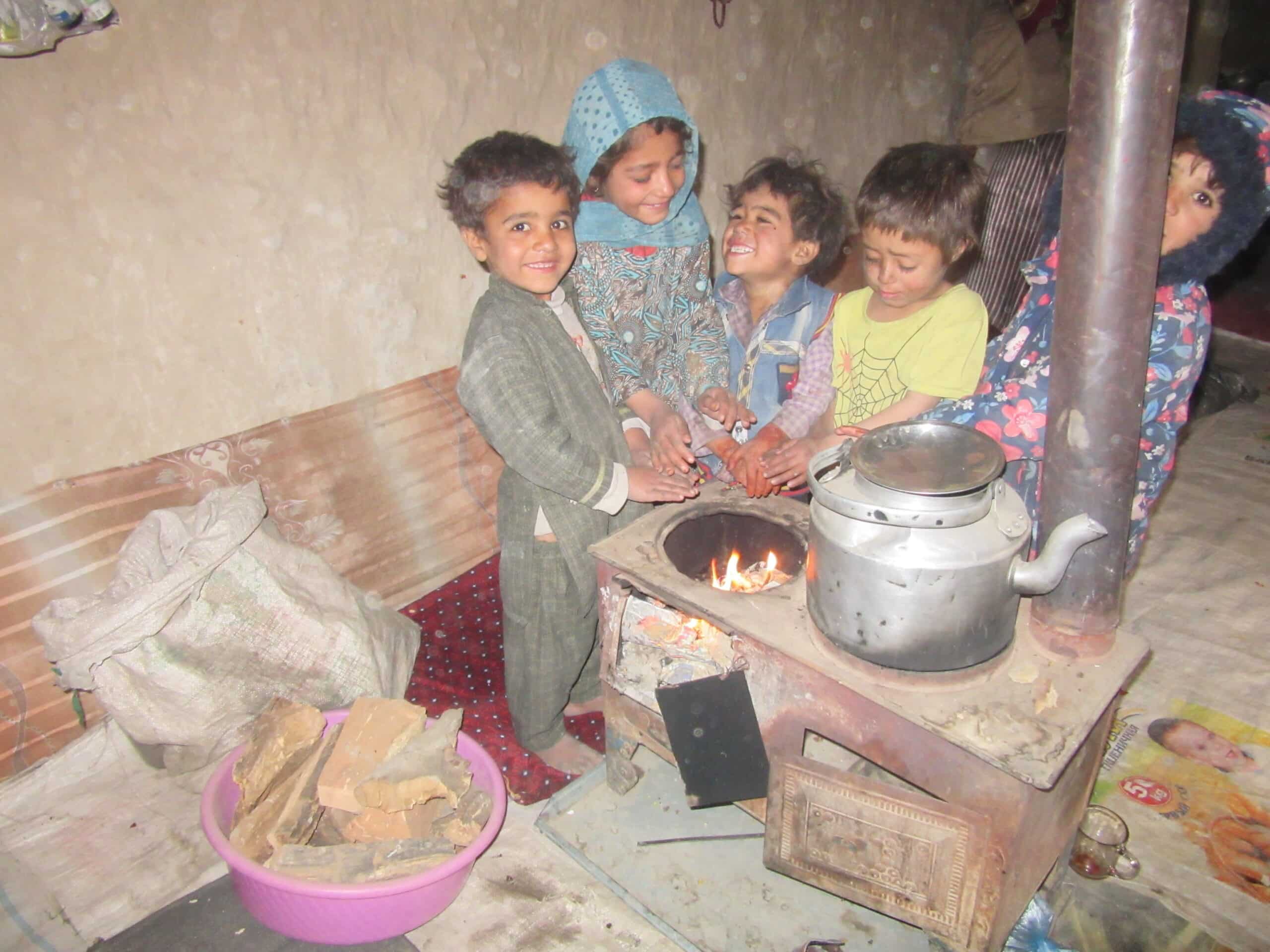 Refugee children around small fire Refugee children around small fire